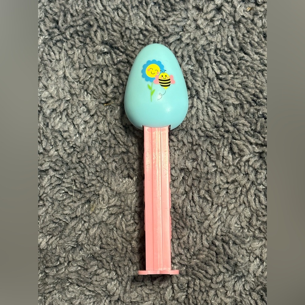 NWOT Pink collectible PEZ dispenser with blue egg & sun and bumblebee design